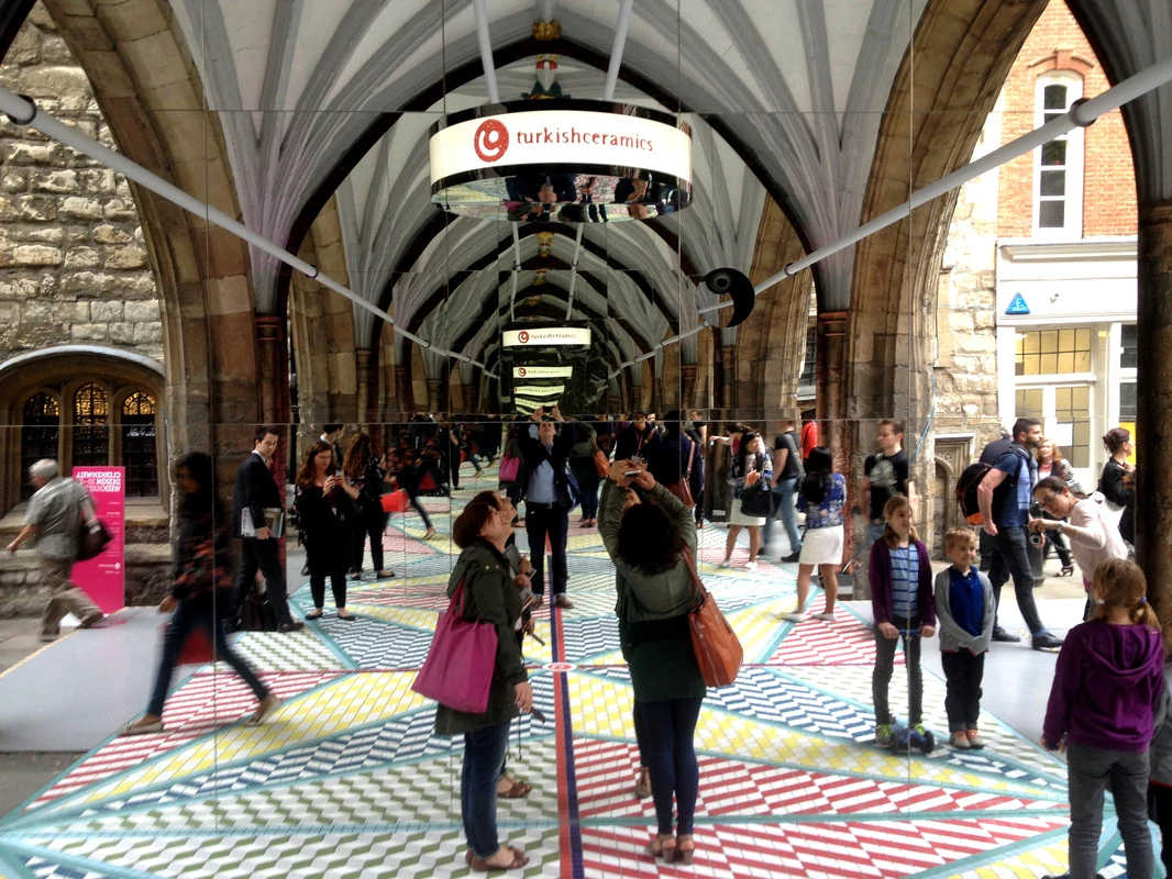 Visitors experience the repeated arches and patterned floor of Tile Mile.