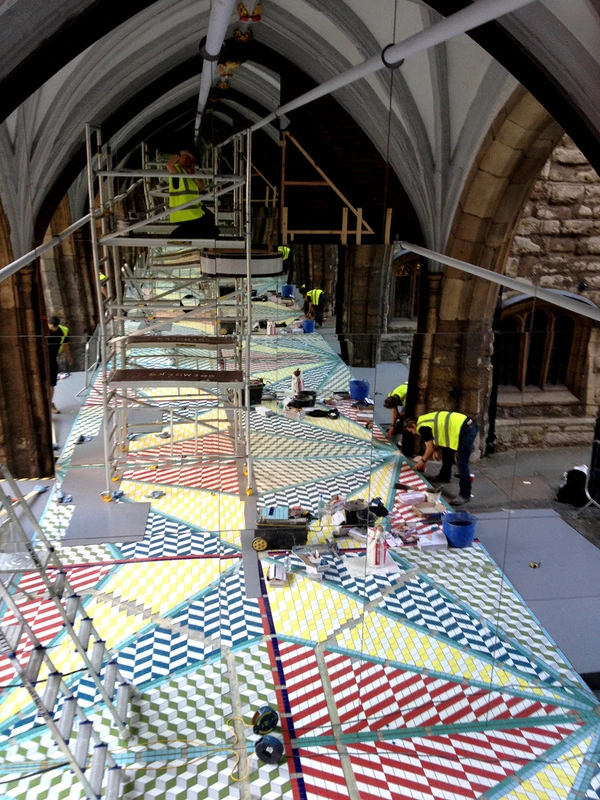 Installation of the tiled floor and mirror structure at St John's Gate.