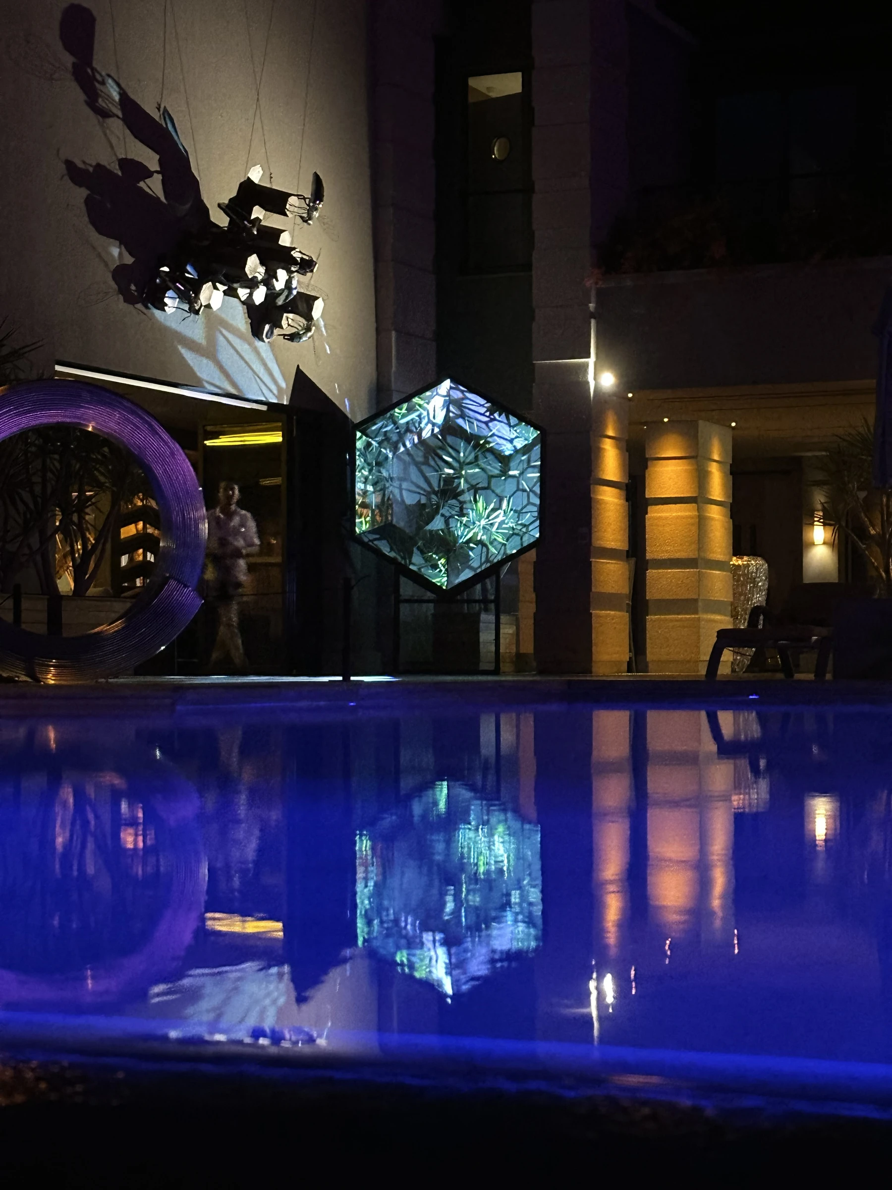 Gateway Mini reflected across the pool after dark