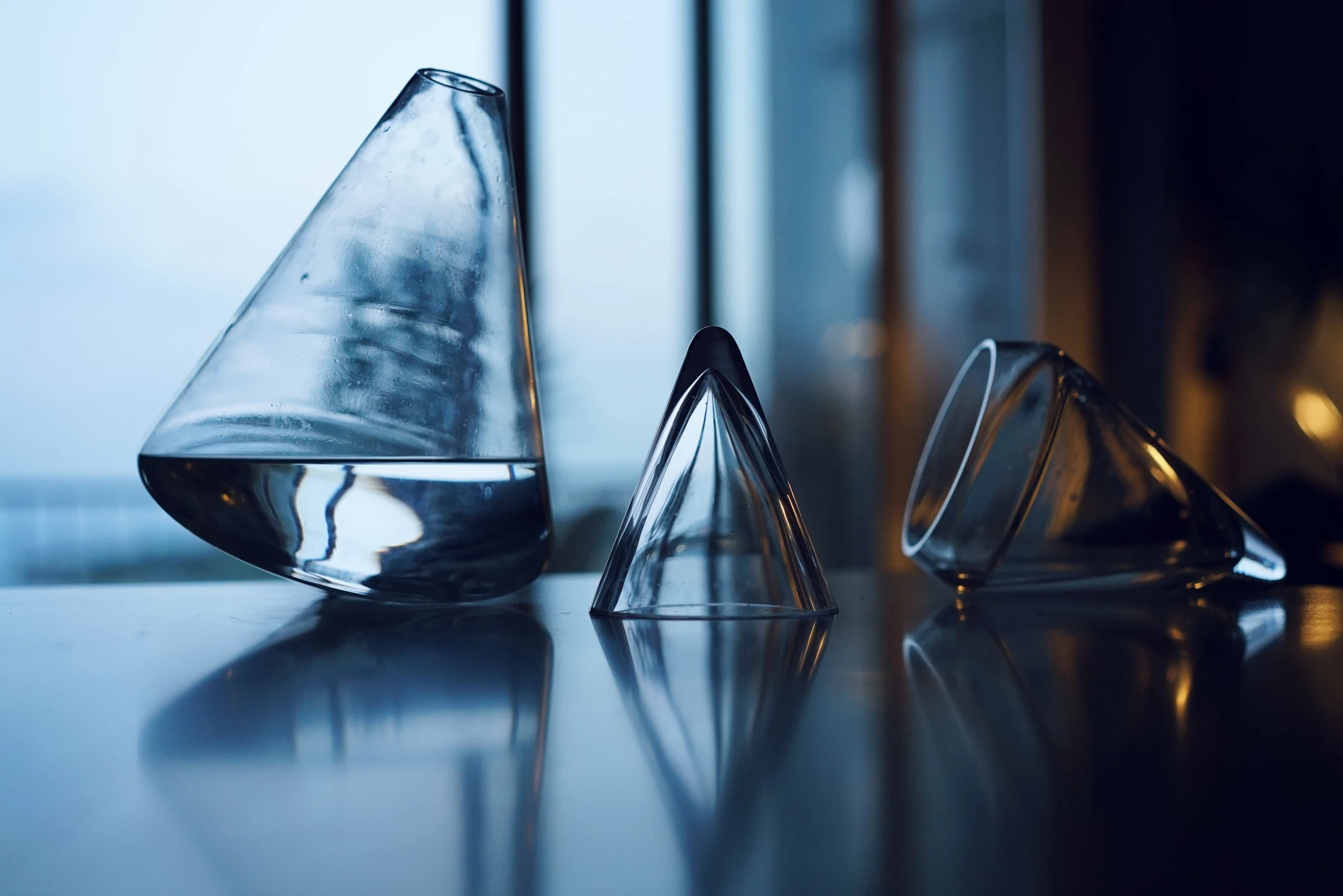 Early glass vessels arranged on a reflective table