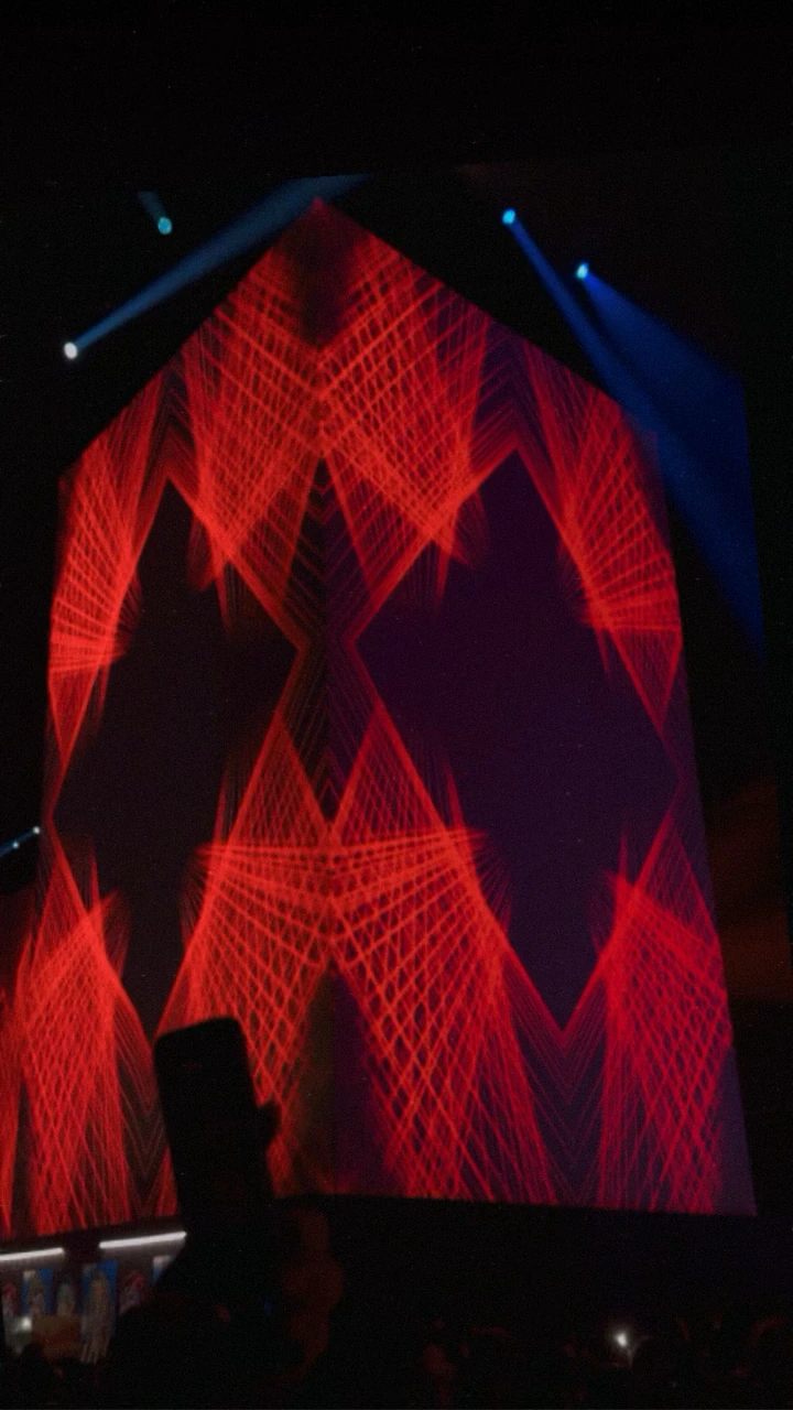 Red filmed-string patterns wrap around the corner of a column, appearing to form a three-dimensional structure at Sensorium Worlds
