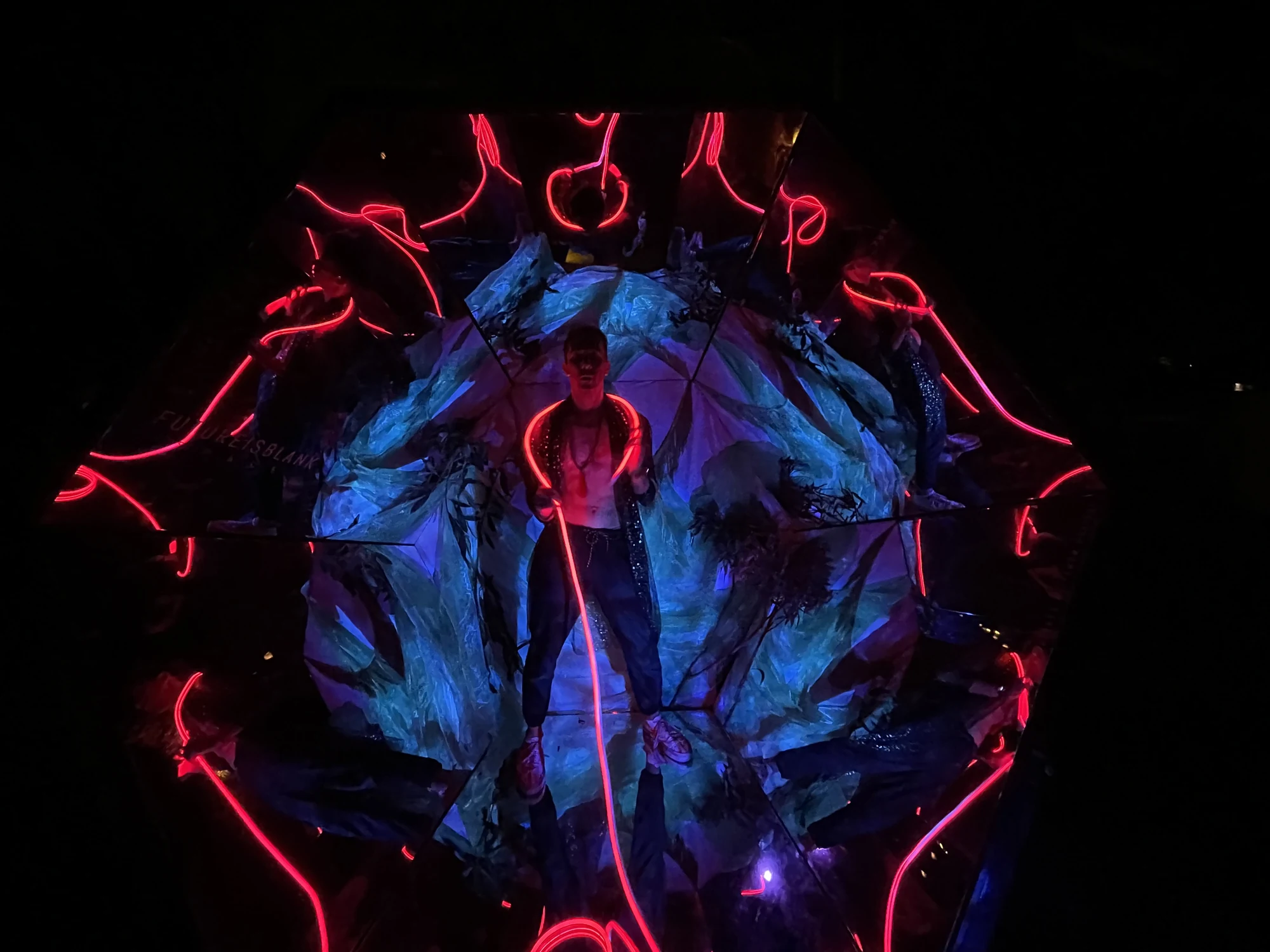 Red light and blue projections around a visitor in Space