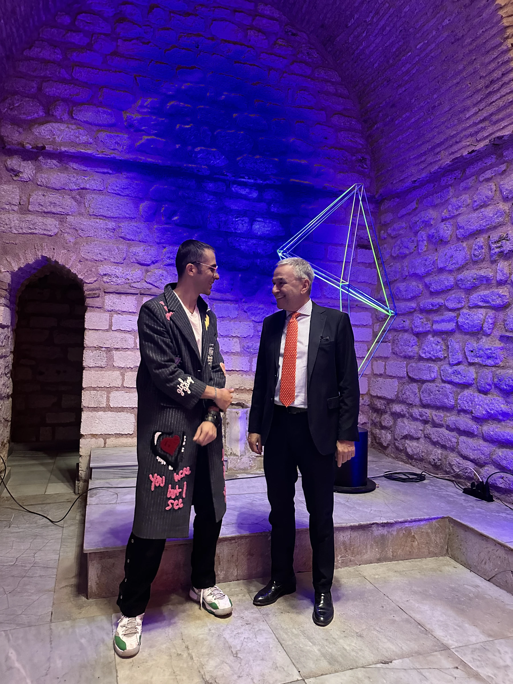 Tamer with a guest in the exhibition room
