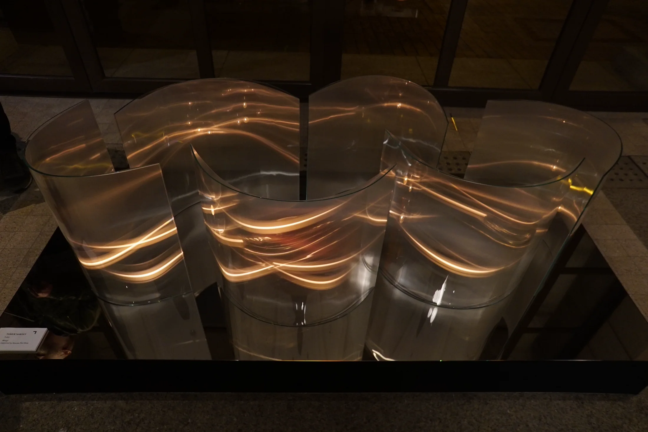 Candlelight multiplied through curved glass panels