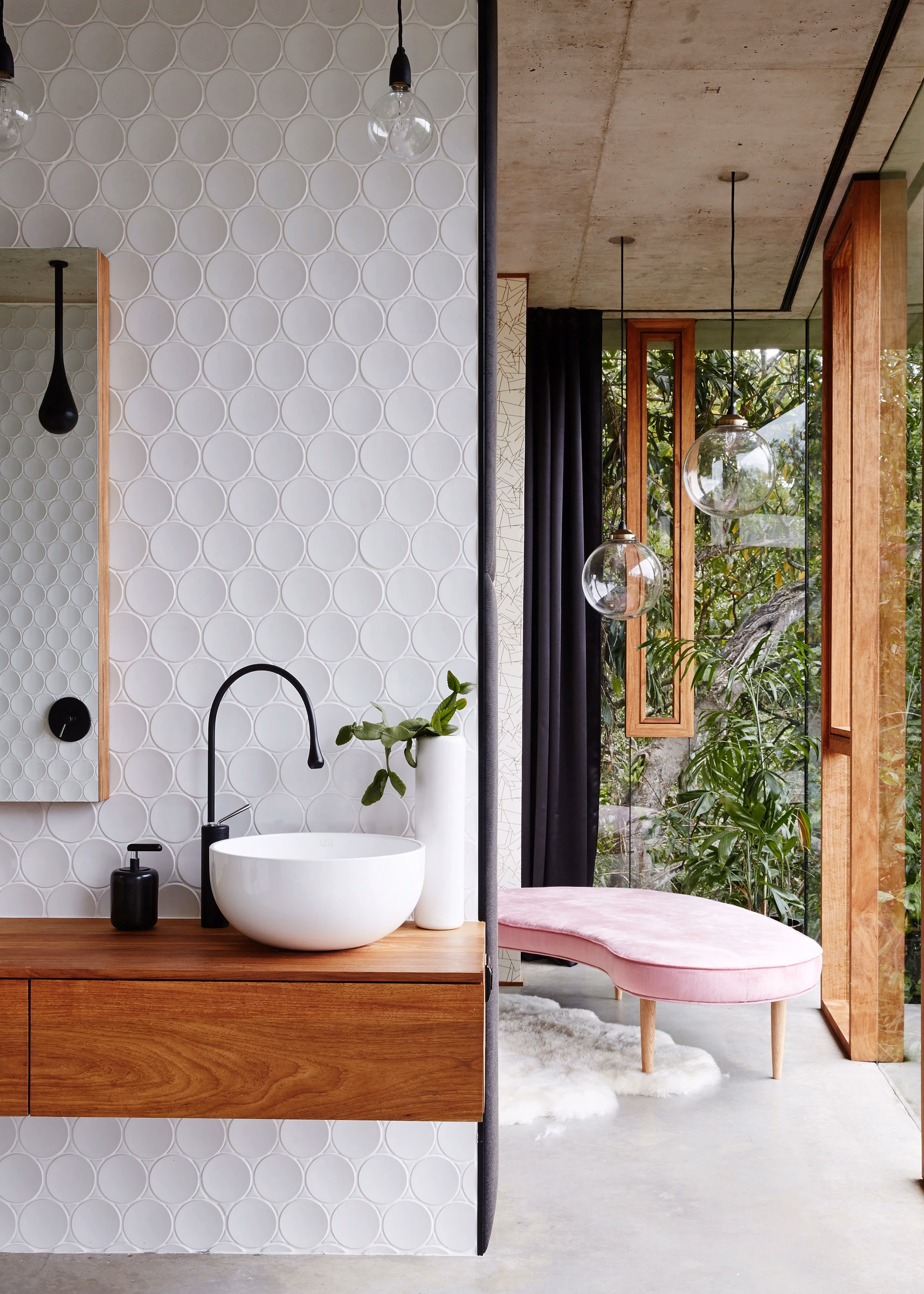 Washbasin and mirror beside the Dot wall and forest view